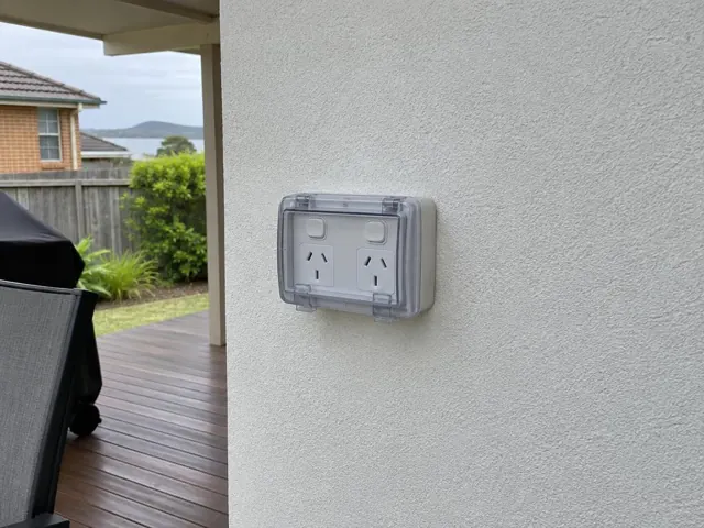 Outdoor double power point on a rendered exterior wall beside a deck in Umina Beach